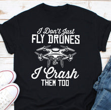 Load image into Gallery viewer, a t - shirt that says i don&#39;t just fly drones i crash
