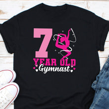 Load image into Gallery viewer, a black shirt with a pink number seven on it
