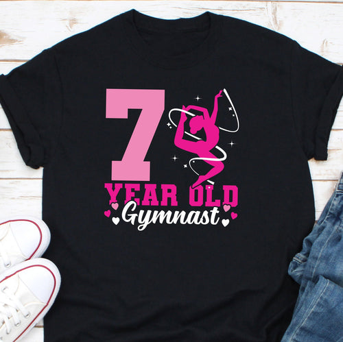 a black shirt with a pink number seven on it