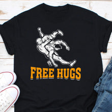 Load image into Gallery viewer, a black t - shirt with the words free hugs on it
