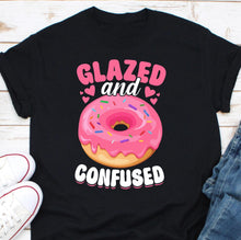 Load image into Gallery viewer, a black shirt with a pink frosted donut on it
